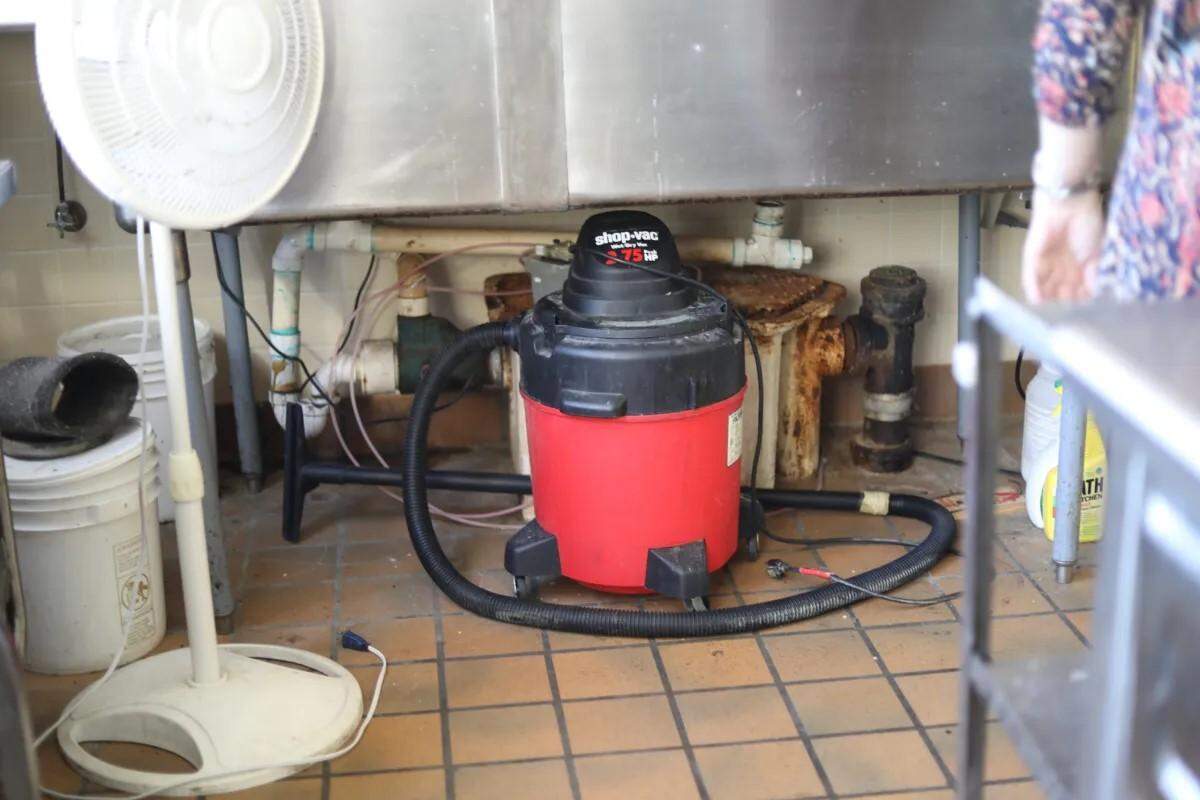 Rusted pipes and a vacuum sit under a sink that has been unusable for years in NEMCC’s culinary arts lab last month.