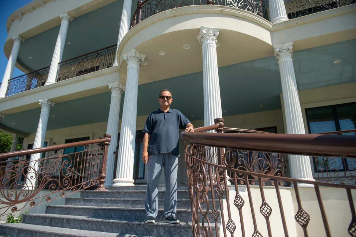 Binoy Mishra stands on the granite stairway of his home on Scenic Drive in Pass Christian on Tuesday, May 16, 2023.