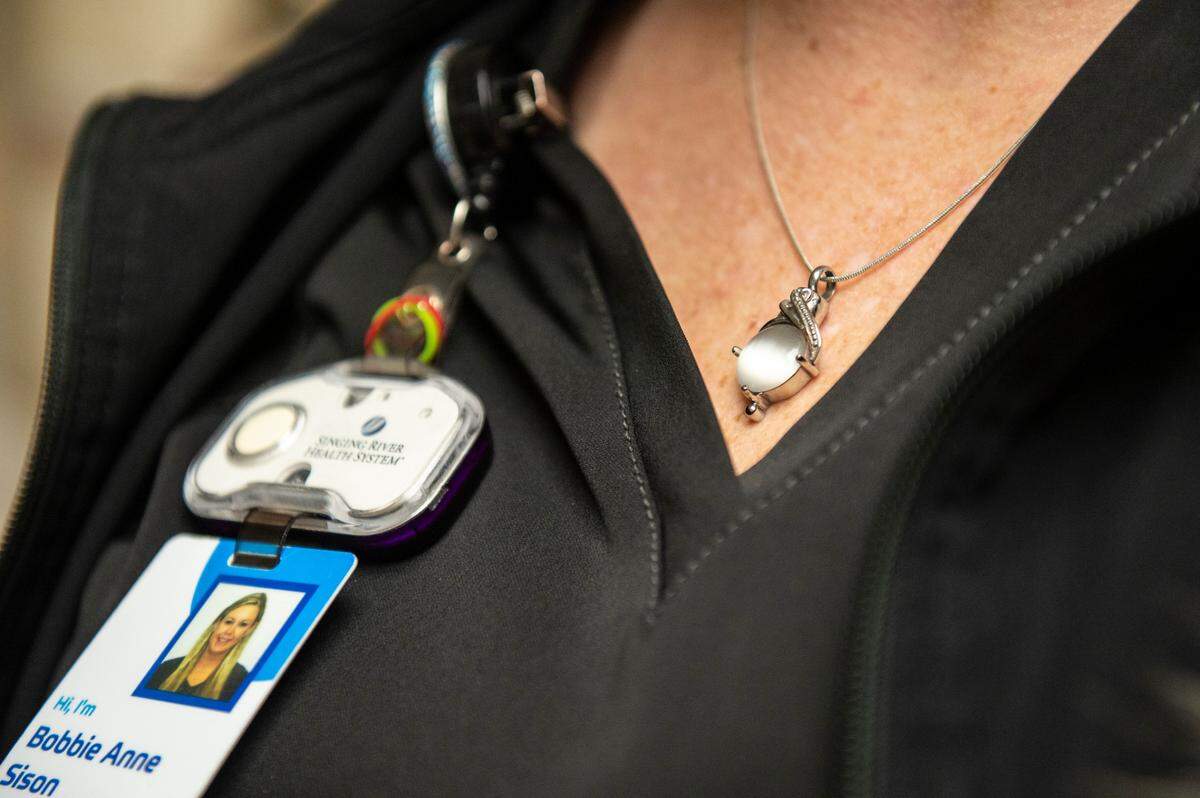 Bobbie Anne Sison, a nurse at Singing River hospital, wears the ashes of her son in a necklace around her neck at Singing River Pascagoula on Wednesday, Dec. 15, 2021.