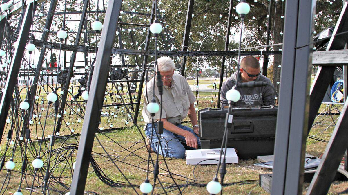 ANITA LEE/SUN HERALD 
 George Manneman, head of Gulfport's harbor, and staff member Billy Lehman are getting ready for the city's inaugural Harbor Lights Winter Festival, running Friday through Jan. 3.