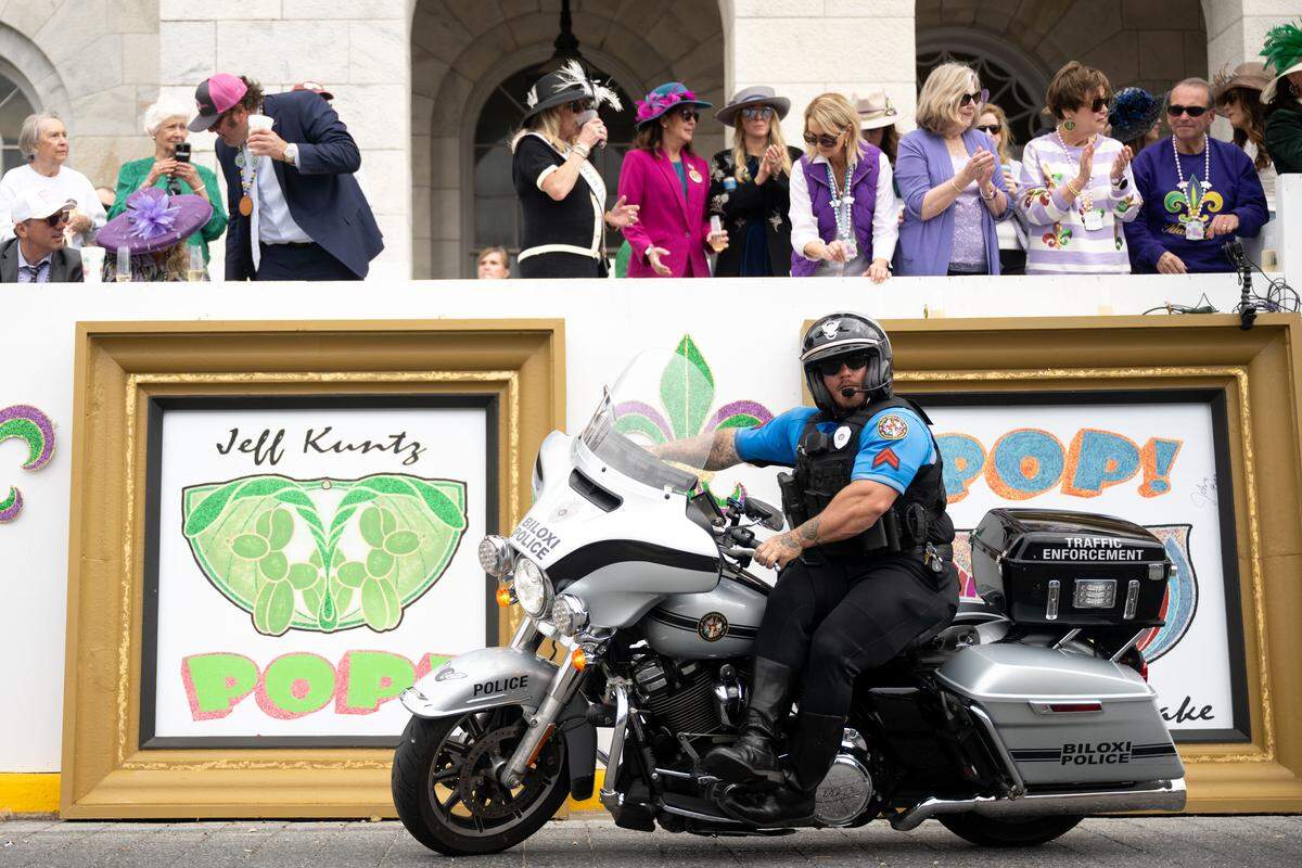 Police officers ride down Lameuse Street on motorcycles during the Gulf Coast Carnival Association’s Fat Tuesday parade in Biloxi on Tuesday, Feb. 17, 2026.