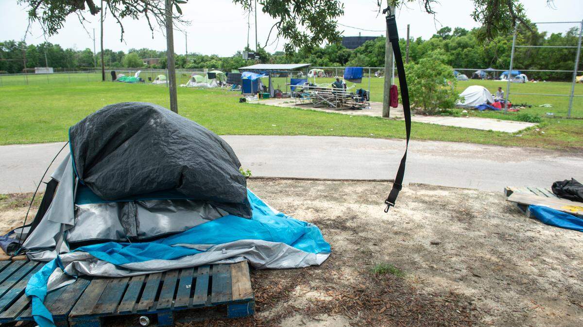 This photo shows an encampment of people experiencing homelessness in Biloxi, Mississippi. New squatter laws in Georgia have stiffened penalties for squatters.