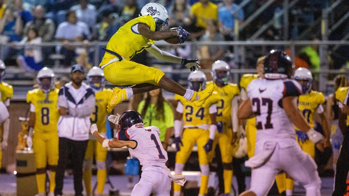 St. Martin’s Noreel White jumps over Hancock’s Coby Kern as he runs the ball down the field during a game against Hancock at Joe Barlow Stadium in St. Martin on Friday, Sept. 30, 2022.