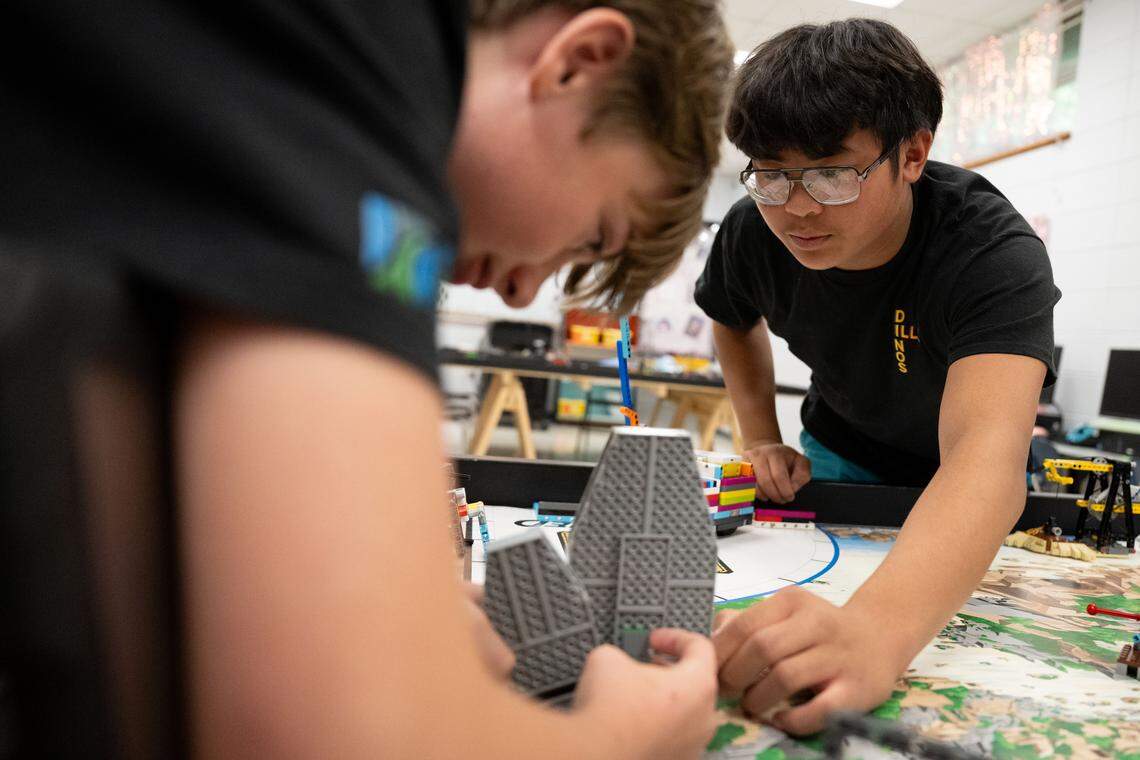 Reynold Vo, right, and Baer Densing, left, make adjustments to their robot during a test run at D’Iberville Middle School on Wednesday, April 15, 2026.
