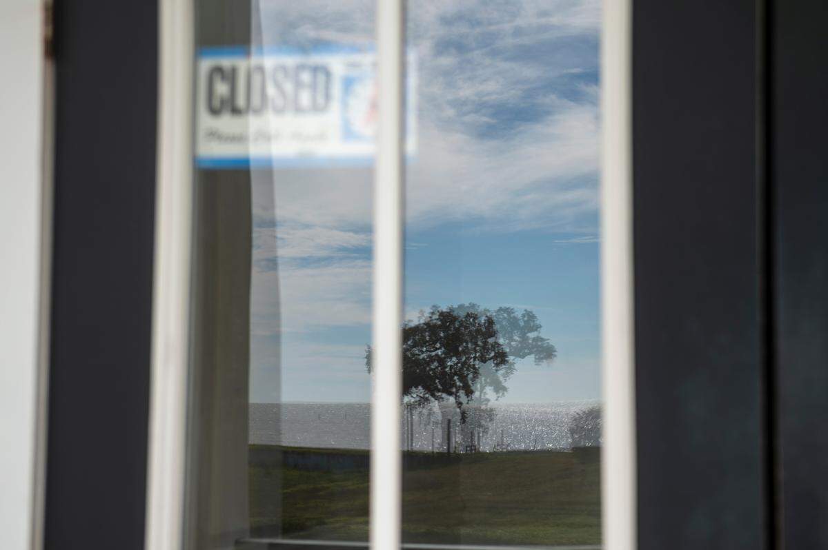 A closed sign hangs in the window of the former clubhouse of Great Southern Golf Club on Wednesday, Nov. 9, 2022. The club, which closed in May, is supposed to be developed into housing developments but neighbors are concerned about the environmental impact.