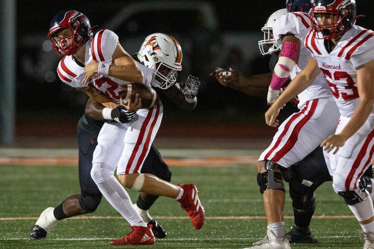 Hancock quarterback Dylan Moran gets sacked by West Harrison’s Brandon Davis during a game at West Harrison High School in Harrison County on Friday, Oct. 6, 2023.