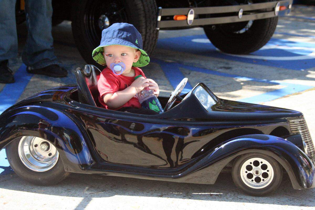 Jace Richardson of Kounteze, Texas., rides through the Biloxi Town Green in his custom-built mini 1937 Ford Coup on in 2015 during the Crusin’ The Coast.