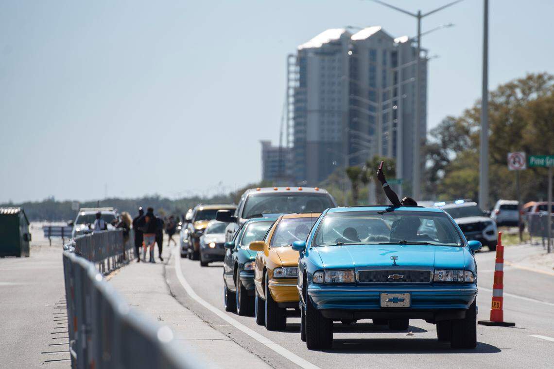 A spring breaker takes a photo from his car as he sits in traffic along Highway 90 during Black Spring Break in Biloxi on Saturday, April 9, 2022.