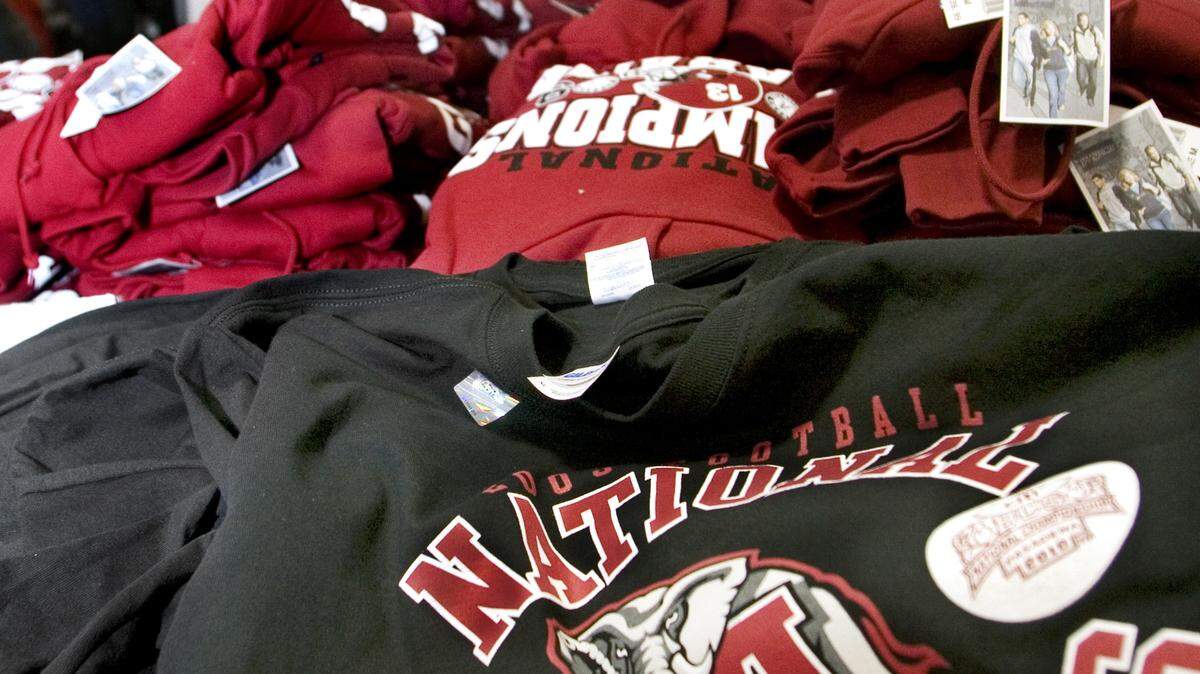 Robin Trimarchi rtrimarchi@ledger-enquirer.com/2010 
 Mark Freiler of Columbus sorts through stacks of Alabama national championship sweatshirts. Shoe Station in D'Iberville announced it will be selling Alabama championship T-shirts immediately after the game if the Tide wins Monday night.