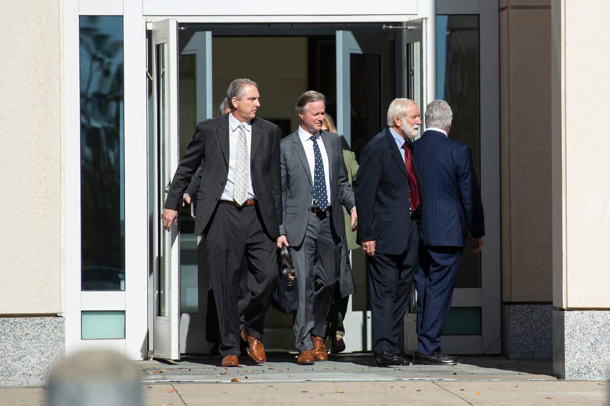 Todd Rosetti, left, sales manager of Quality Poultry & Seafood, and Clell Rosetti, right, a corporate representative of Quality, walk out of the federal courthouse in Gulfport with their attorneys on Wednesday, Dec. 11, 2024, after their sentencing in a federal seafood mislabeling case.
