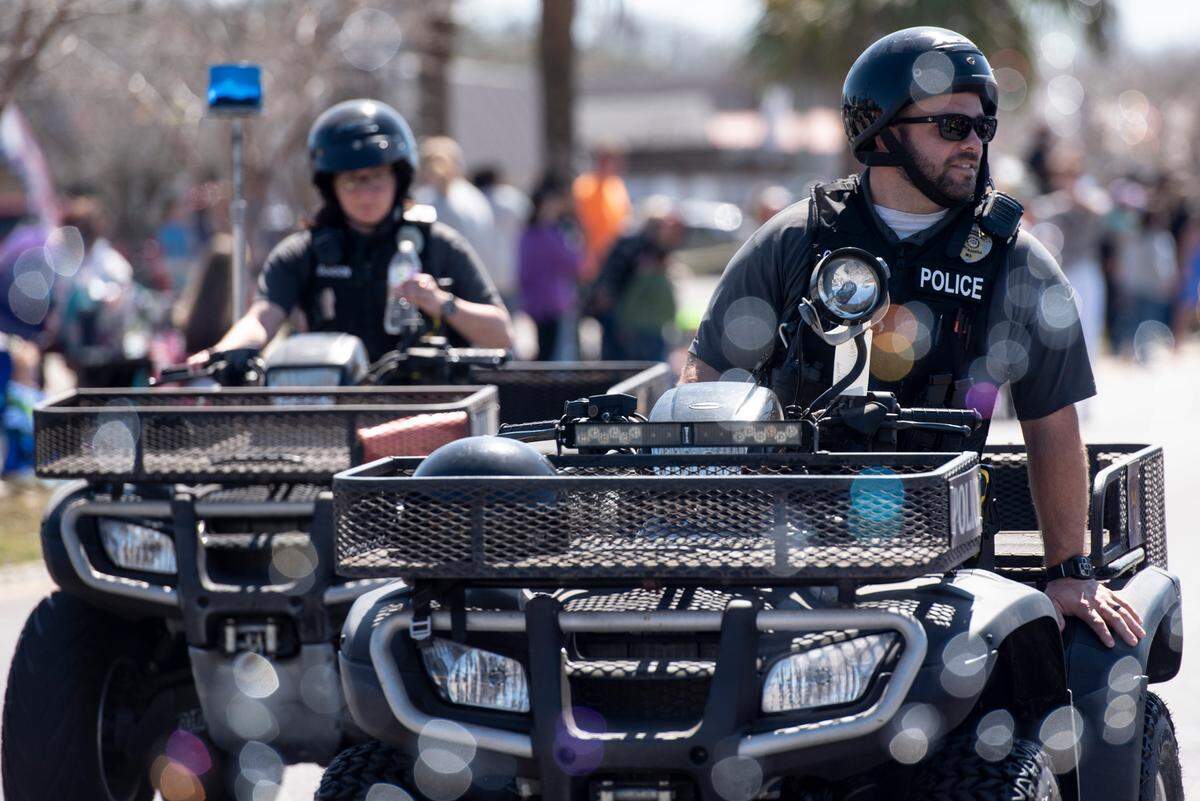 Pascagoula police do crowd control during the Jackson County Carnival Association Mardi Gras parade in Pascagoula on Saturday, March 1, 2025.