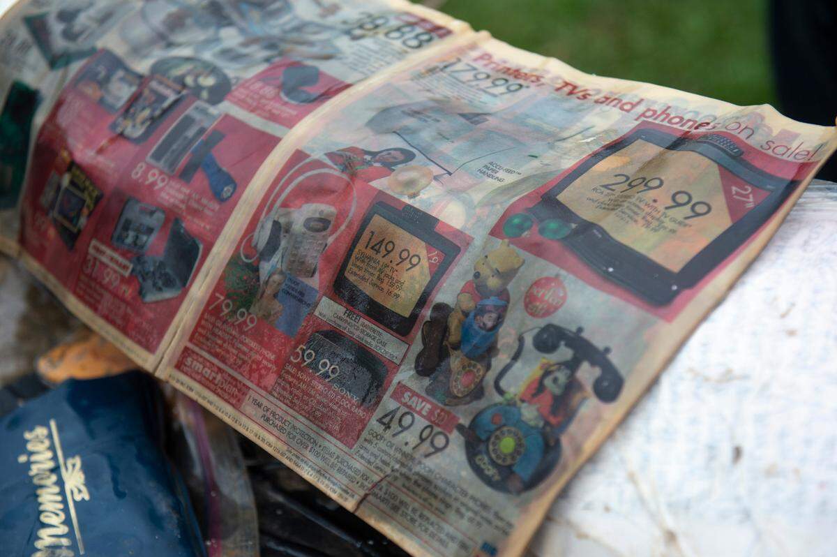 A K-Mart ad showing televisions and phones for sale was among the items from a time capsule that was buried at W. J. Quarles Elementary in Long Beach in 1999 and opened on Friday, Dec. 13, 2024.