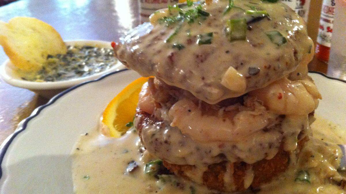 TAMMY SMITH/SUN HERALD Eggplant Algiers is a stack of fried eggplant medallions, crab cake and boiled shrimp and crabmeat, topped with a light cream sherry sauce. It's served at Louie & The Redhead Lady in Bay St. Louis.