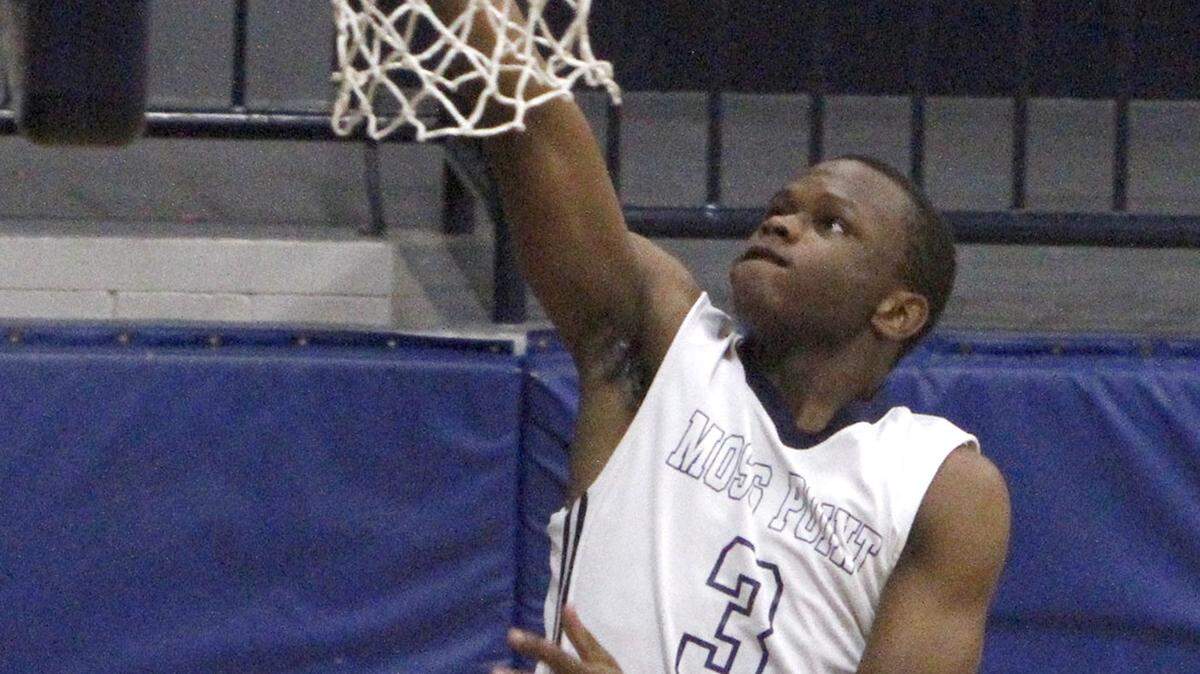 TIM ISBELL/SUN HERALD 
 Moss Point's Marcus Brown scores two against George County, Saturday, Dec. 11, 2015.