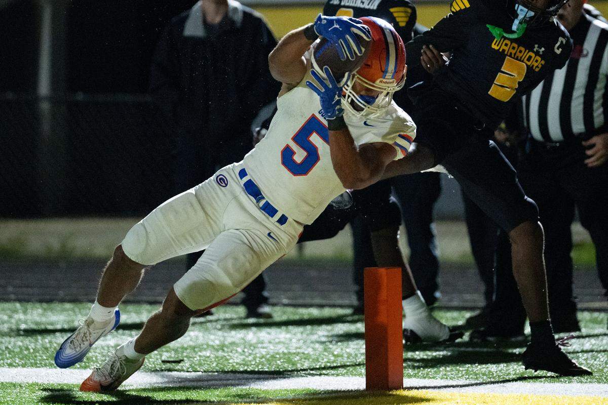 Gulfport running back Cooper Crosby (5) leaps into the end zone for a touchdown during a football game at Warrior Stadium on Friday, Oct. 31, 2025.