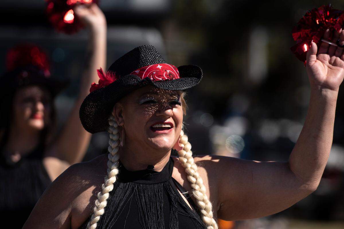 A member of Southern Chaos dance group waves at the crowd during the Krewe of Nereids Mardi Gras parade on Highway 90 in Bay St. Louis on Sunday, Feb. 12, 2023.