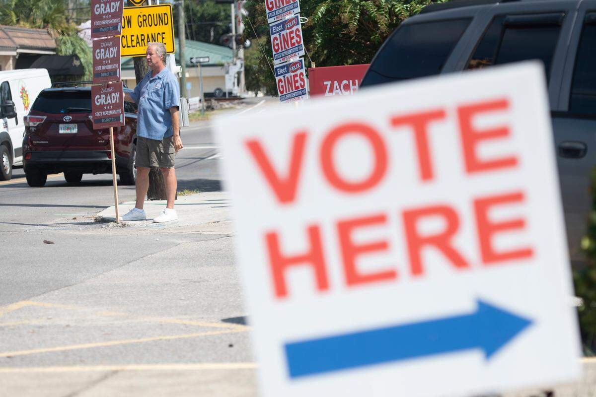 Vincent Creel campaigns for Zachary Grady, who is running to be the Republican candidate for State Representative District 115, during a primary election runoff outside the Lopez Quave Public Safety Center in Biloxi on Tuesday, Aug. 29, 2023.