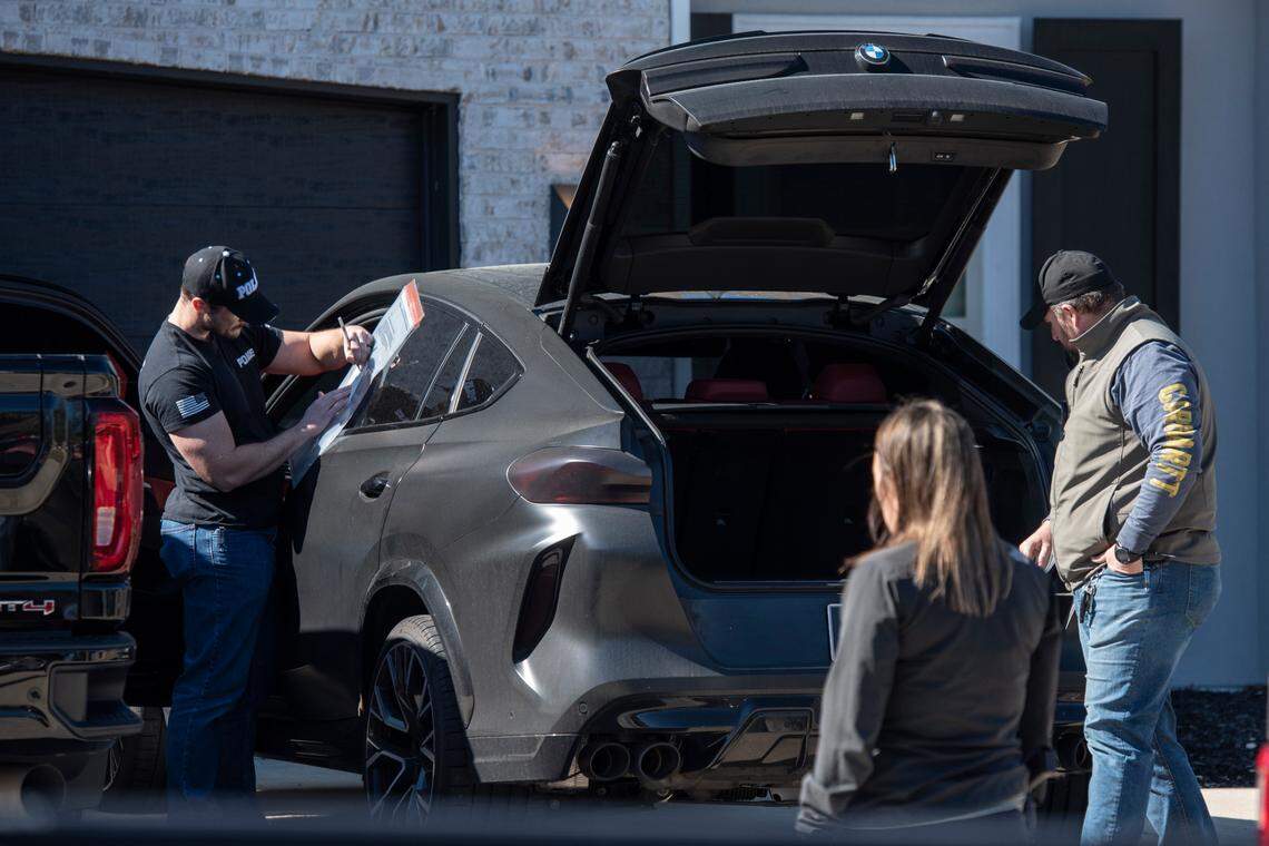 Drug Enforcement Administration agents and other law enforcement officers search two cars as a part of raids conducted on the home of Biloxi Councilman Robert Deming III on Thursday, Jan. 26, 2023. Agents would not say specifically what they were looking for or what they found, but agents also conducted raids on several locations of The Candy Shop & Kratom, a kratom store chain owned by Deming.