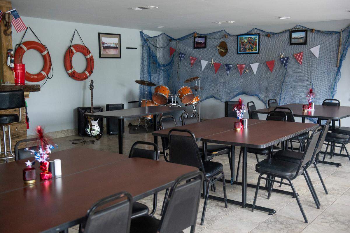 The dining area inside Woolmarket Grocery in Biloxi has a bar made with reclaimed wood and bolted together to enhance the nautical theme.