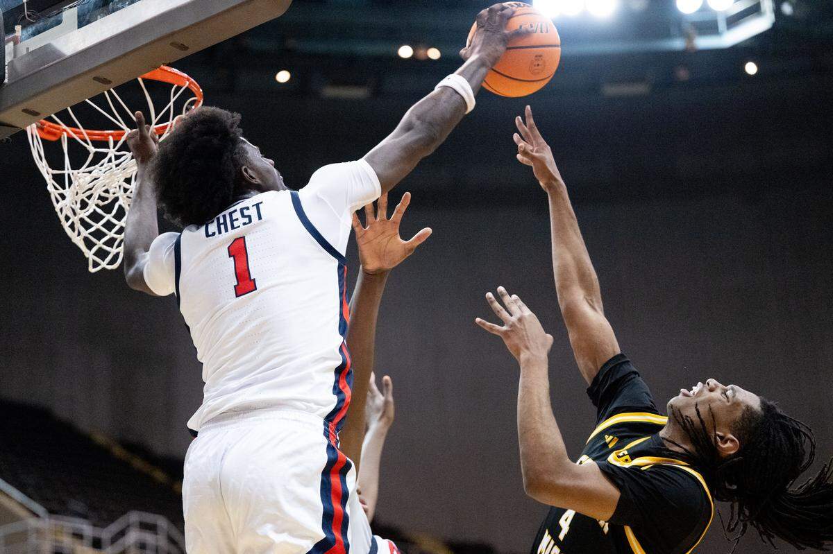 Mississippi forward Corey Chest (1) deflects a shot at the basket by Southern Mississippi forward Tylik Weeks (4).