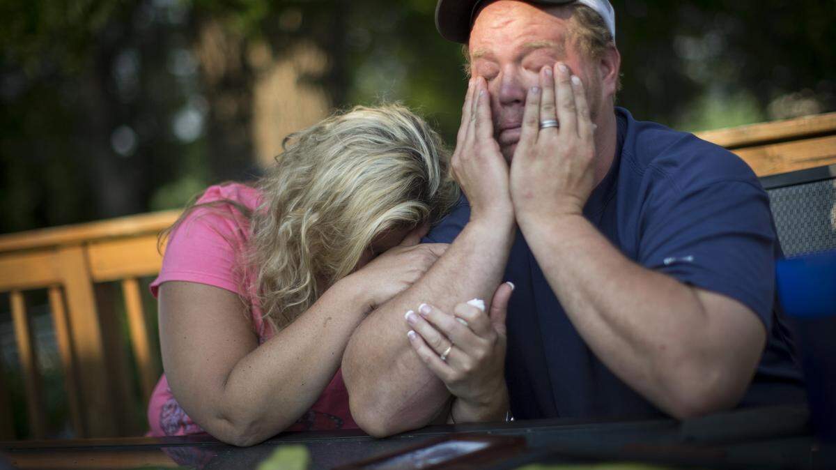 Shelley Fenton cries into her husband Al Fenton's arm on June 8, 2015, as he tearfully tells the story about his two-year-old son Benny's death while riding with him on a skid loader on a farm he worked at in New Richland, Minn. (Renee Jones Schneider/Minneapolis Star Tribune/TNS)