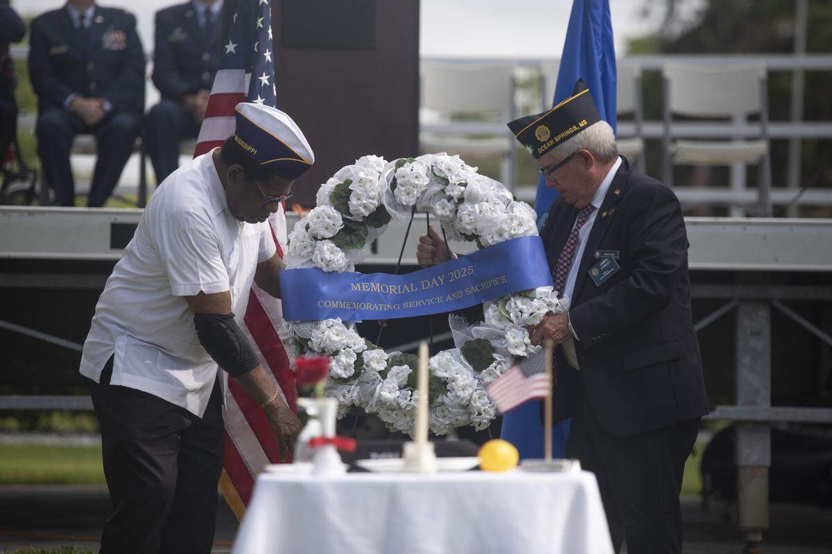 A wreath is presented during a Memorial Day ceremony at Biloxi National Cemetery in Biloxi on Monday, May 26, 2025.