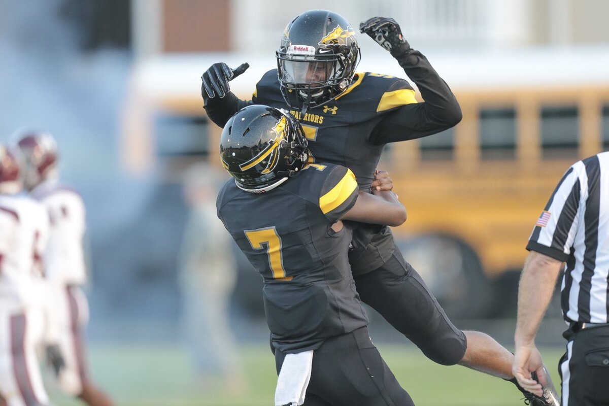 Justin Walley (5) is congratulated by Jaden Walley (7) after scoring early in the Picayune at D’Iberville game, Friday, August 24, 2018.