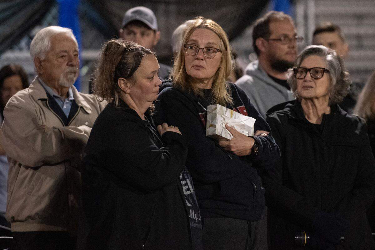 Family members of Sgt. Steven Robin listen to a speech by the police chief during a candlelit vigil for Bay St. Louis Sgt. Steven Robin and officer Branden Estorffe at Tiger Stadium in Bay St. Louis on Thursday, Dec. 15, 2022. Robin and Estorffe were killed on Wednesday when a woman shot both of them.
