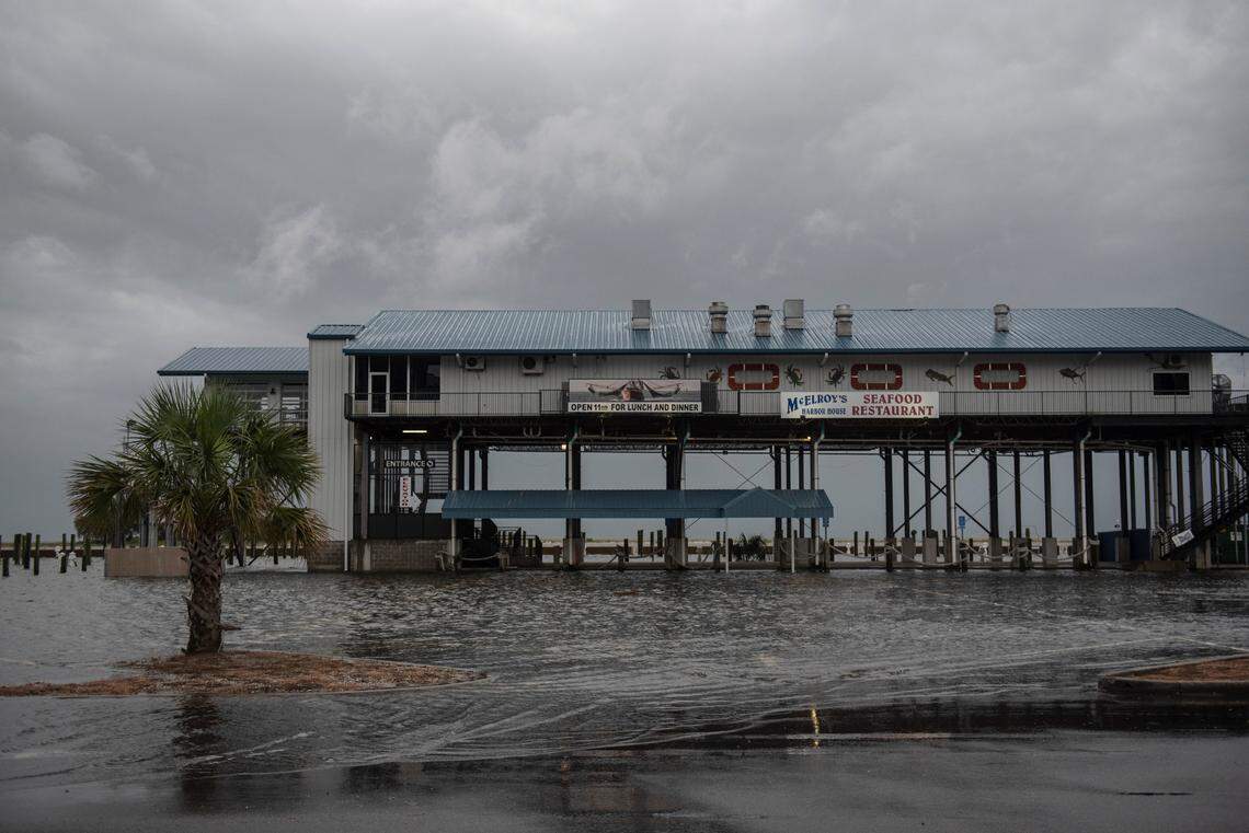 Storm surge floods the parking lot to McElroy’s Harbor House restaurant in Biloxi as Hurricane Ida approaches on Sunday.