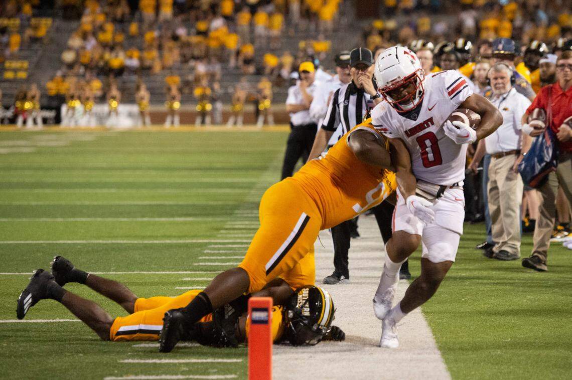 Southern Mississippi defense tackles Liberty running back Dae Dae Hunter (0) during a NCAA college football game in Hattiesburg, Miss., Saturday, Sept. 3, 2022. Southern Mississippi lost 29-27