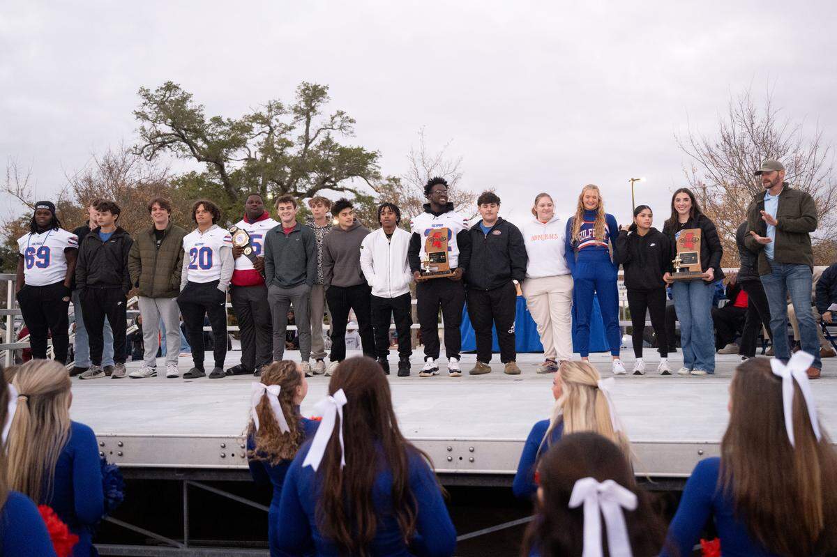 The Gulfport football team, girls powerlifting team and the boys powerlifting team walk on stage as they are congratulated for winning state titles during the Champions Christmas Parade in Gulfport on Monday, Dec. 8, 2025.