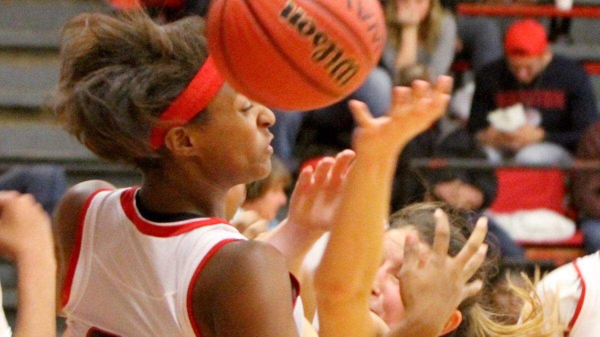 JOHN FITZHUGH/SUN HERALD 
 Bay High's Breanna Fountain battles Harrison Central's Da'Mai Henry for a rebound during the second quarter of their game at Harrison Central on Tuesday Nov. 24, 2015.