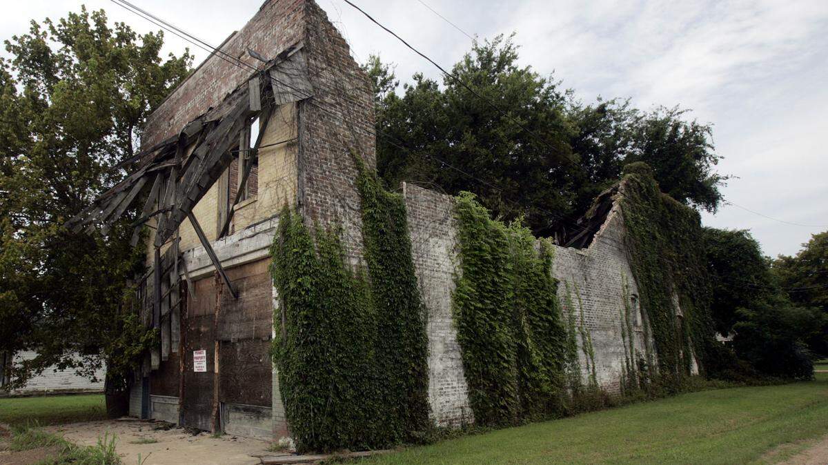 Vines and warning signs are shown on the exterior walls of the two-story, whitewashed brick building that was Bryant’s Grocery & Meat Market in Money, Miss., Aug. 12, 2005. The store is where Emmett Till, a 14-year-old black youth whistled at the owner’s wife and subsequently paid for the action with his life in August 1955. The Mississippi Board of Archives and History is weighing the possibility of putting a marker by the store, but  State Sen. David Jordan, D-Greenwood, says somebody -- the state or a private investor -- needs to buy the dilapidated building and rehabilitate it.