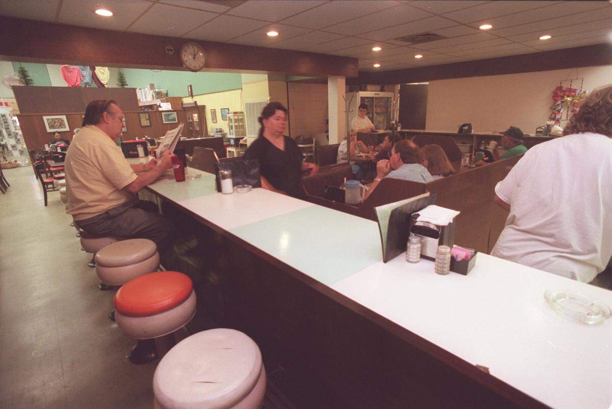 Waitresses move behind the counter while customers waits in booths and the lunch counter for the daily lunch specials at Triplett-Day Drug Company on the corner of 14th St. and U.S. 49 in Gulfport in this Sun Herald file photo.