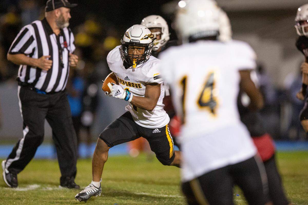 Oak Grove’s JQ Gray evades Harrison Central’s defense during a game against Harrison Central at Milner Stadium in Gulfport on Friday, Aug. 26, 2022.
