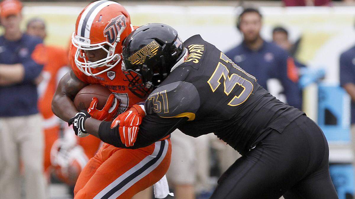 TIM ISBELL/SUN HERALDAnthony Swain of Southern Miss brings down UTEP's LaQuintus Dowell, Saturday, Oct. 31, 2015. 