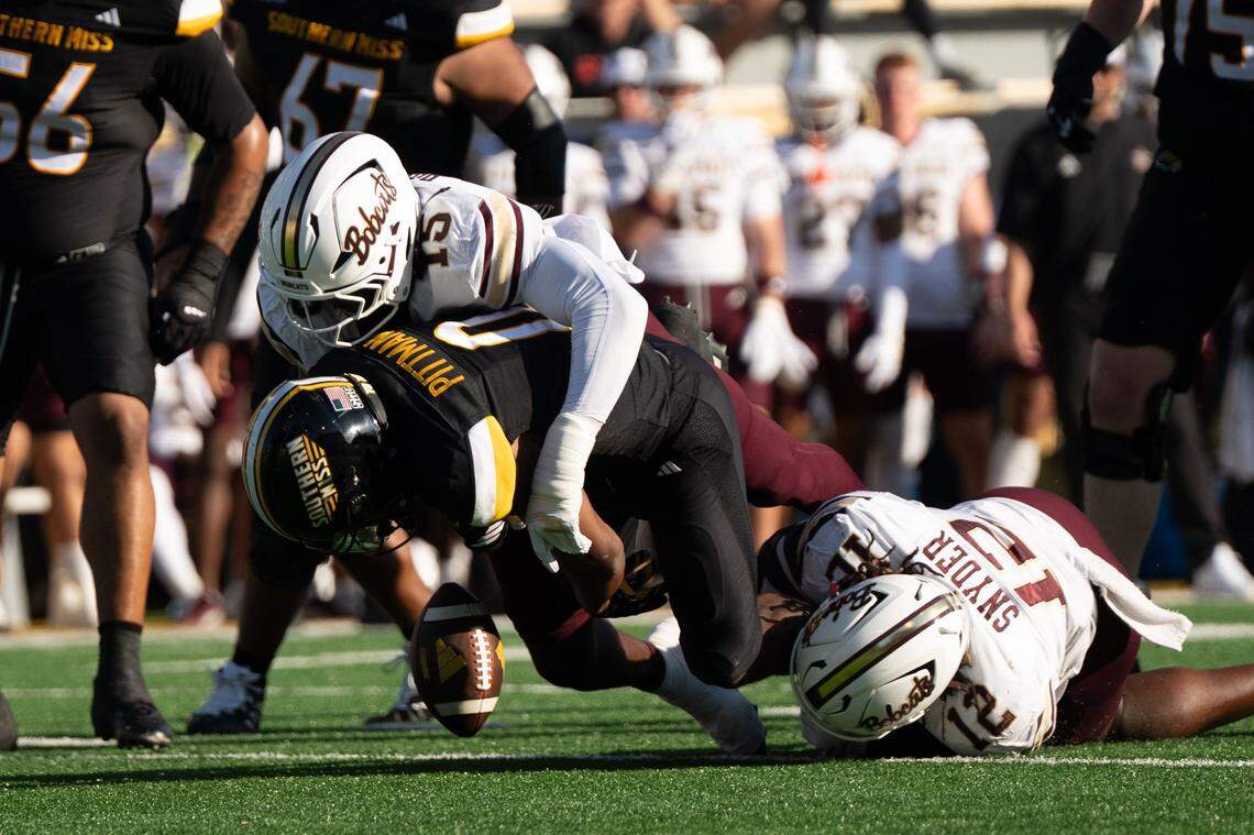Southern Miss running back Jeffery Pittman (0) fumbles Saturday after being tackled by Texas State linebacker Donterry Russell (15).