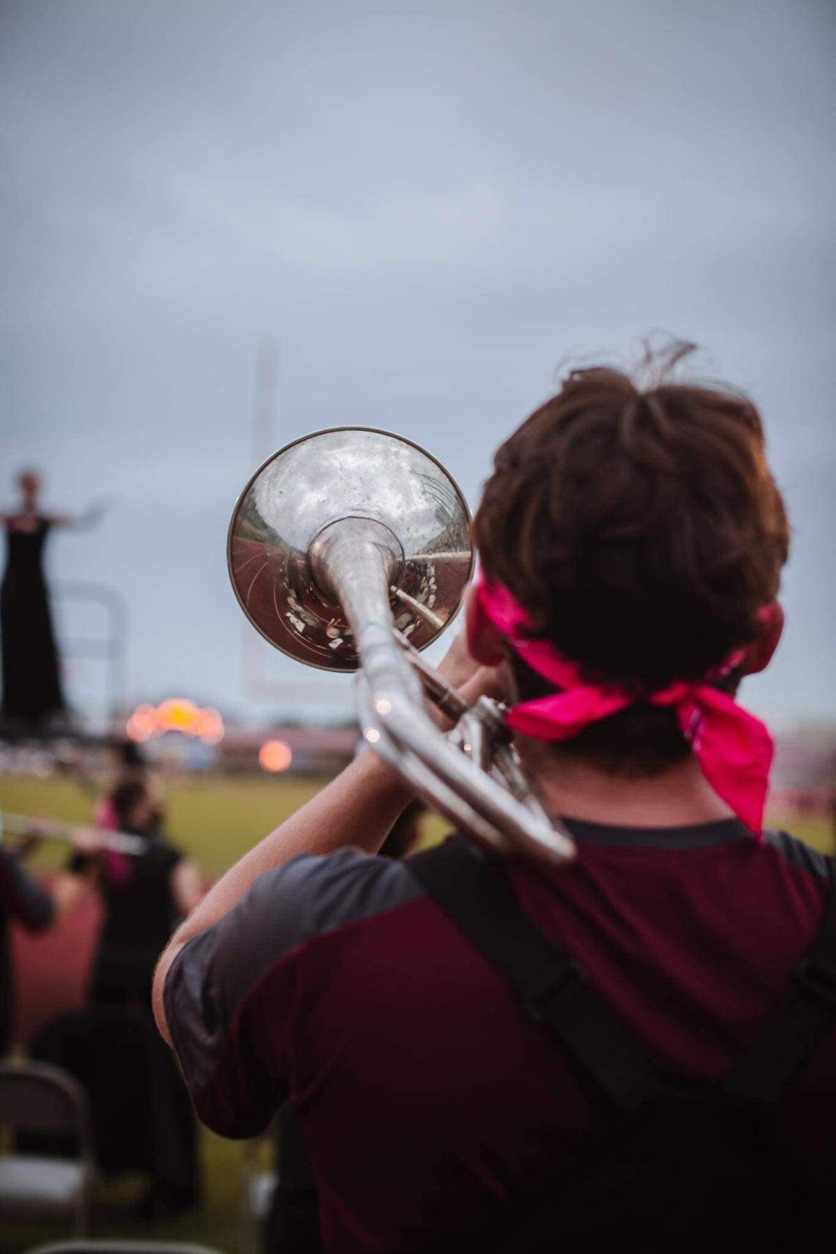 A trumpet player performs for Long Beach High School marching band during 2021 football season.