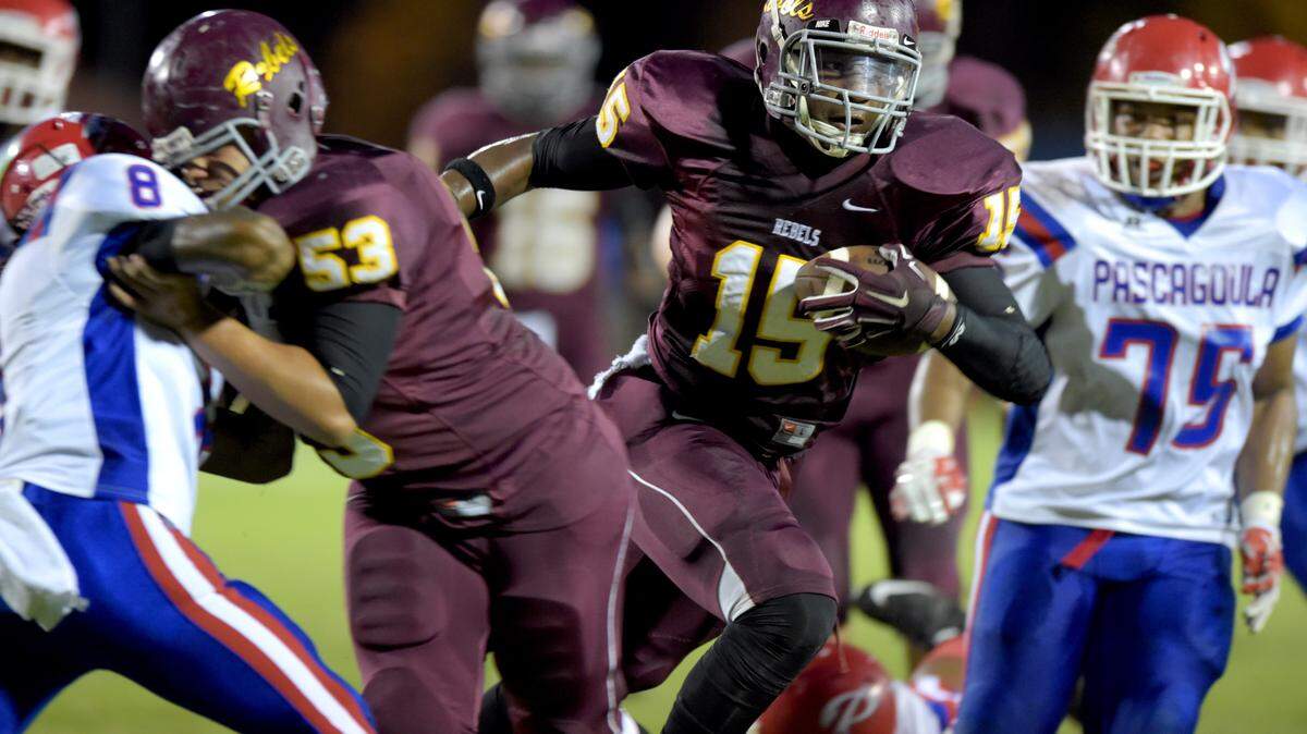 GLENN ANDREWS/SPECIAL TO THE SUN HERALD 
 George County wide receiver Dwan Williams (15) runs the ball for a touchdownas Pascagoula defensive end/defensive tackle Michael Robinson (75) defends at right during the second quarter, Friday, Sept. 11, 2015, at George County High School in Lucedale, Miss.