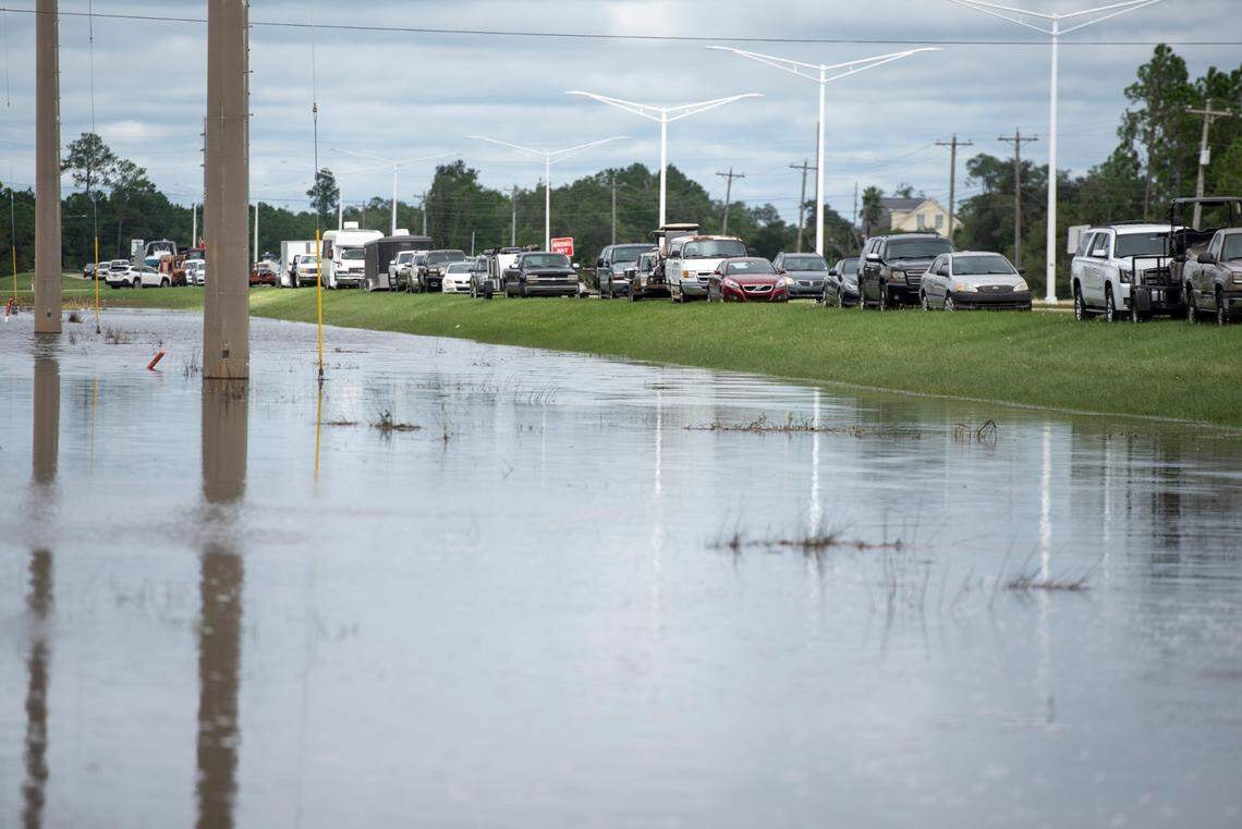 Cars are parked along MS 603 near Shoreline Park Thursday after Hurricane Francine. Shoreline Park flooded during the storm and vehicles were moved to higher ground.