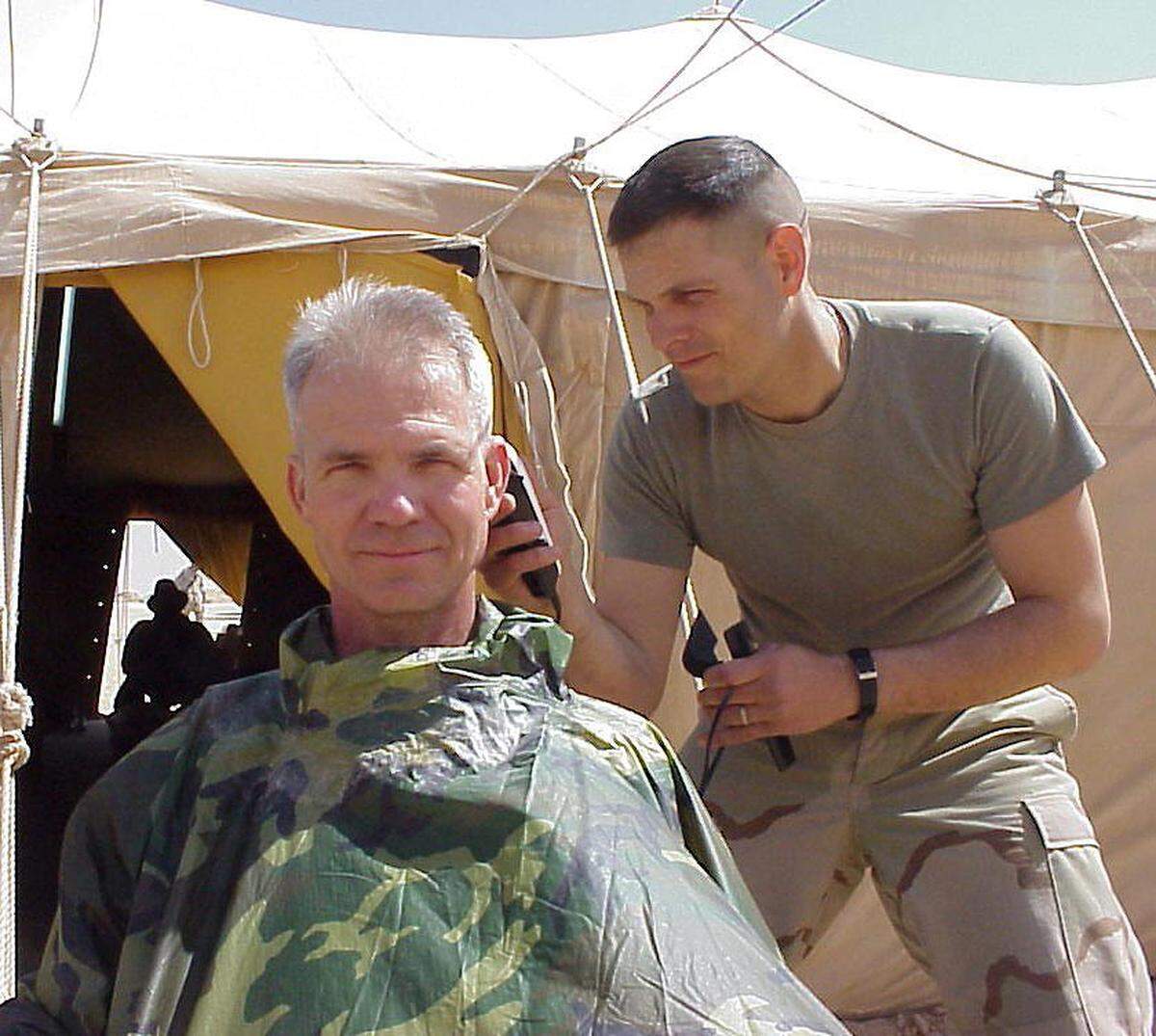 Maj. Dan Yaroslaski gives Sun Herald military reporter Patrick Peterson a haircut in March 2003. Peterson was in Kuwait reporting on about 80 Marine reservists from Gulfport during the Iraq War.