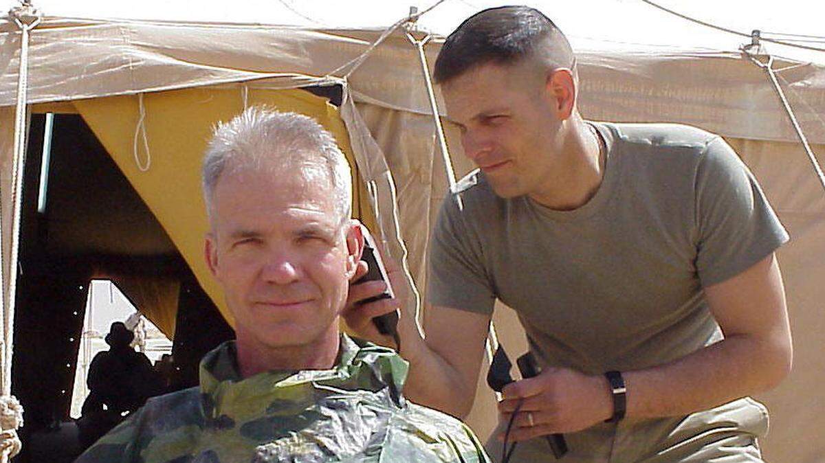 Maj. Dan Yaroslaski gives Sun Herald military reporter Patrick Peterson a haircut in March 2003. Peterson was in Kuwait reporting on about 80 Marine reservists from Gulfport during the Iraq War.