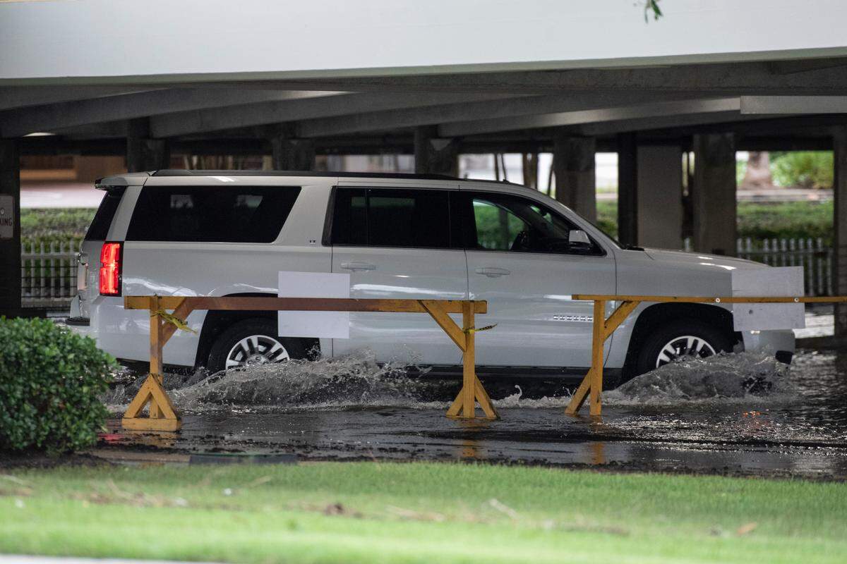 A vehicle drives through flood waters in the parking garage at Palace Casino Resort in Biloxi after Hurricane Francine on Thursday, Sept. 12, 2024.