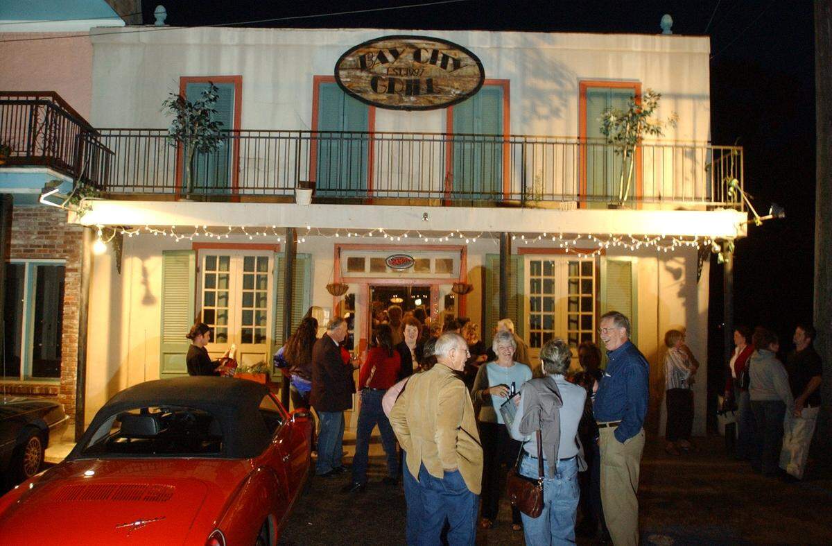 Friends of the Animal Shelter in Hancock County held a benefit calendar signing at Bay City Grill in Bay St. Louis in 2004.