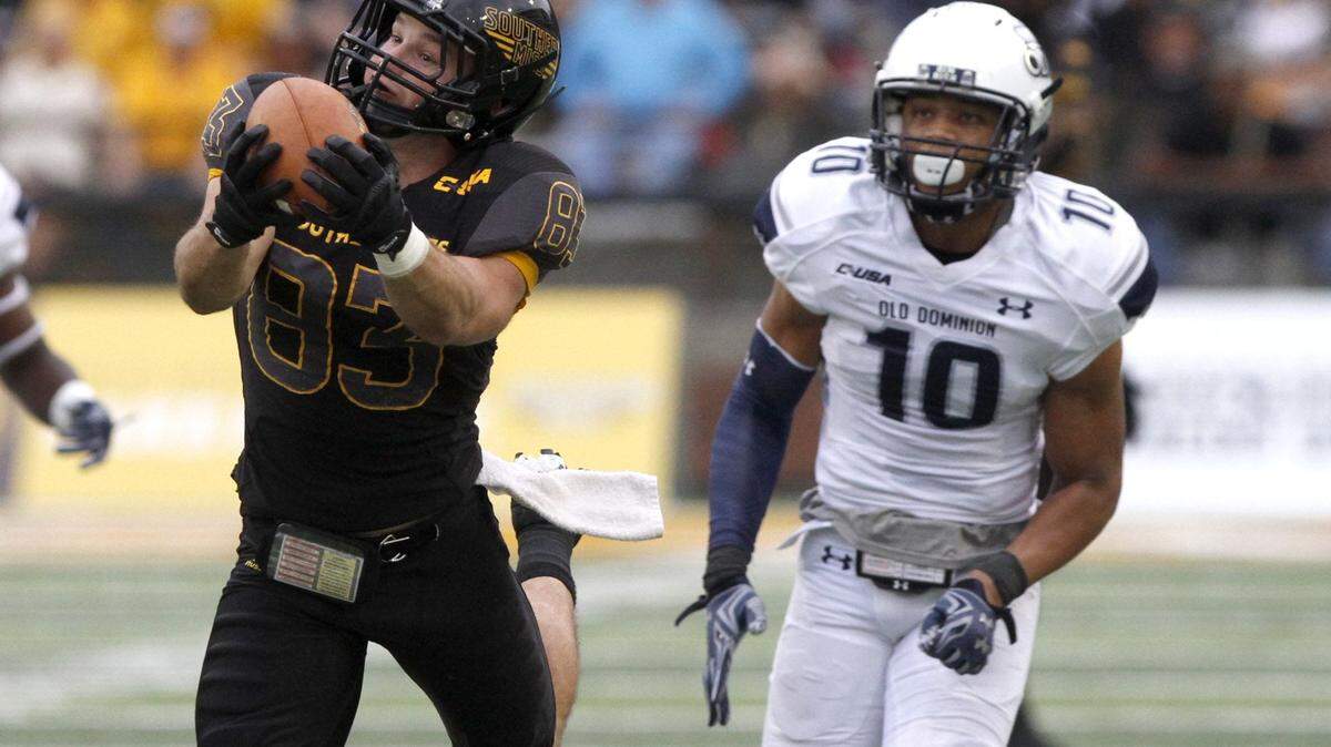 TIM ISBELL/SUN HERALD 
 Southern Miss receiver Casey Martin catches a Nick Mullens pass over Old Dominion's Sean Carter, Saturday, Nov. 21, 2015.