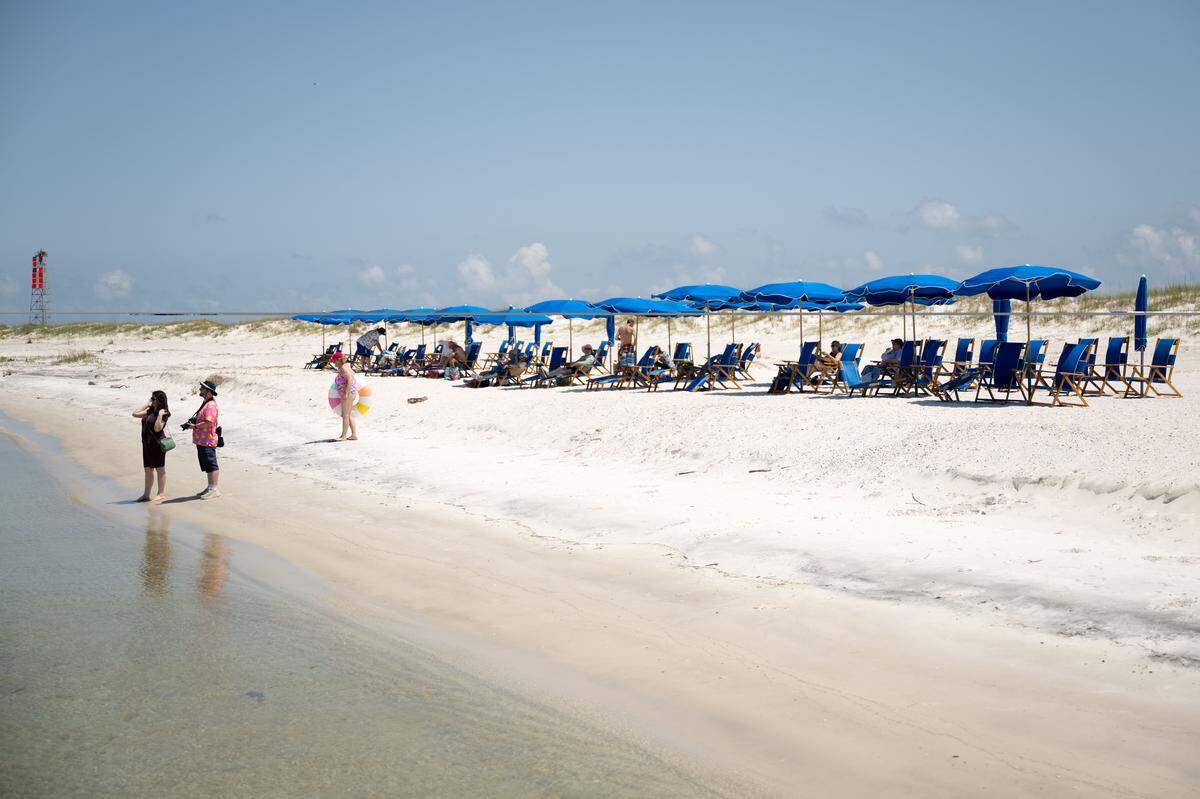 Visitors enjoy the beach on the north side of Ship Island during a recent day trip on a Gulfport-based Ship Islands Excursion ferry on Wednesday.