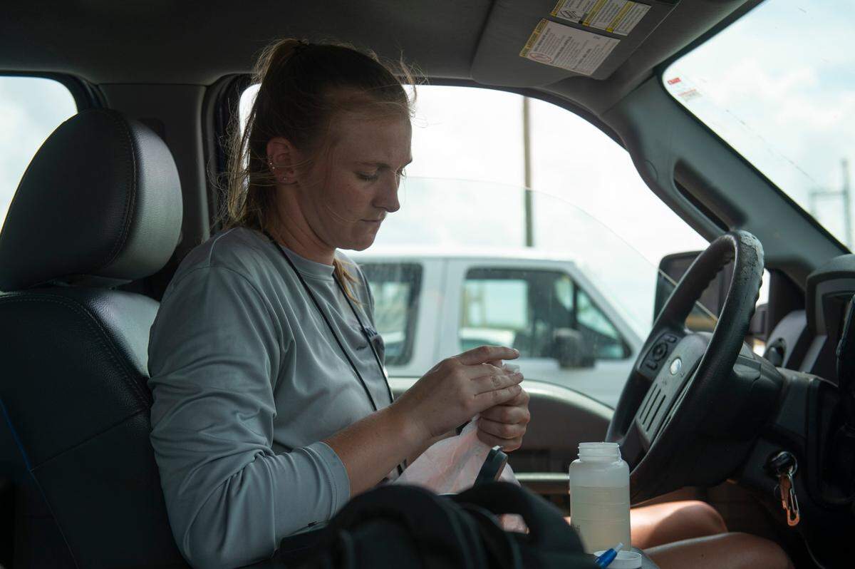 Jennifer Ahlbrand, an environmental natural resource specialist with the Mississippi Department of Environmental Quality, records data from a water sample collected at one of several sites along Mississippi Coast beaches on Wednesday, April 30, 2025.