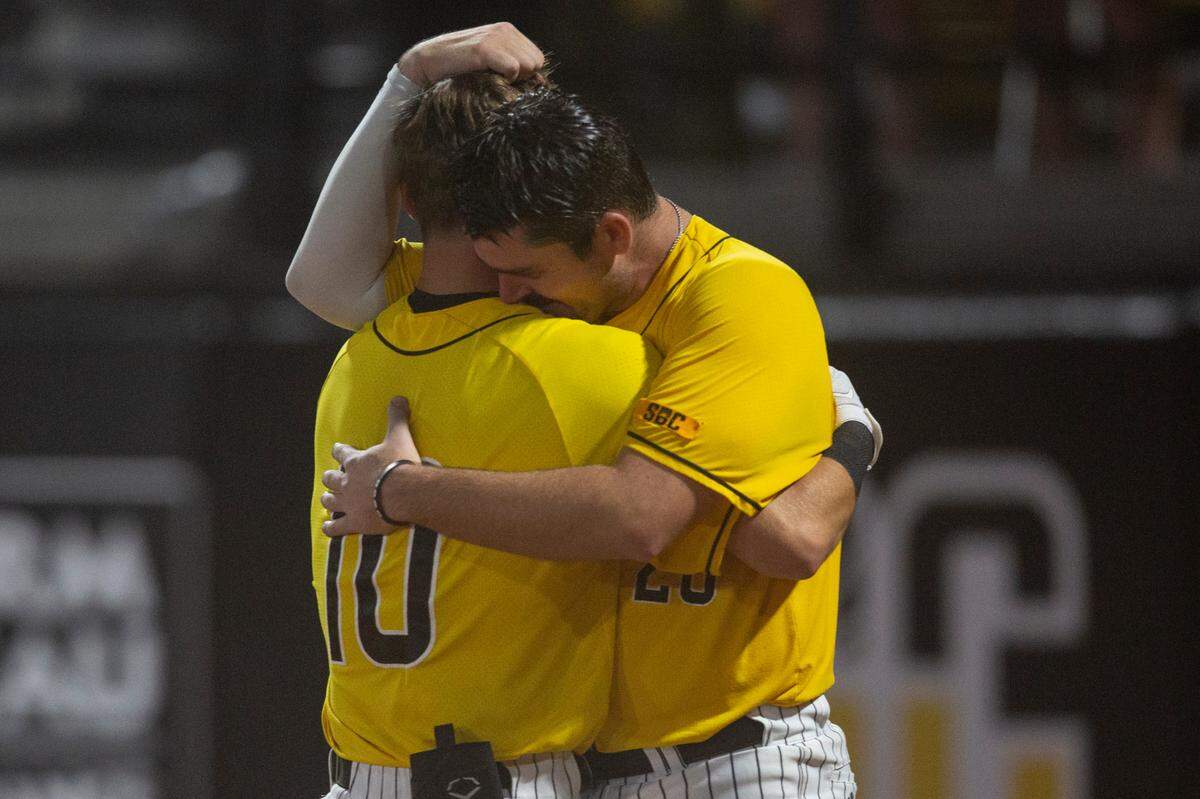 Southern Miss’ Dustin Dickerson and Tanner Hall embrace after Southern Miss lost to Tennessee in the NCAA Super Regional at Pete Taylor Park in Hattiesburg on Monday, June 12, 2023.