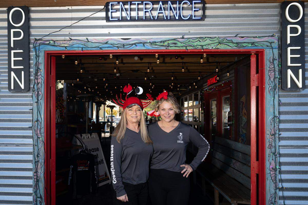 Sumer Steelman, right, and Michelle Schenck, left, stand at the entrance to Crawfish House and Grill in Ocean Springs. They recently purchased the former Huck’s Cove and are preparing for the opening of  Crawfish House on the Bayou in Gautier.