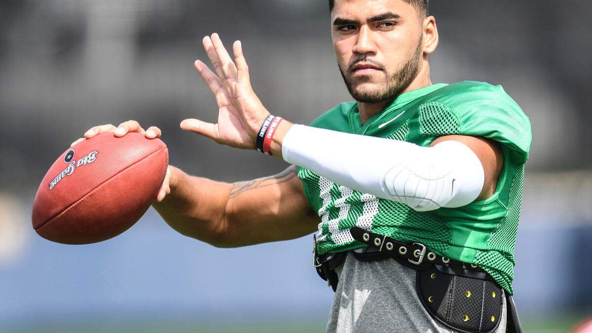 Ole Miss quarterback Jordan Ta’amu passes at  NCAA college football practice in Oxford, Miss., Wednesday, Aug. 15, 2018.